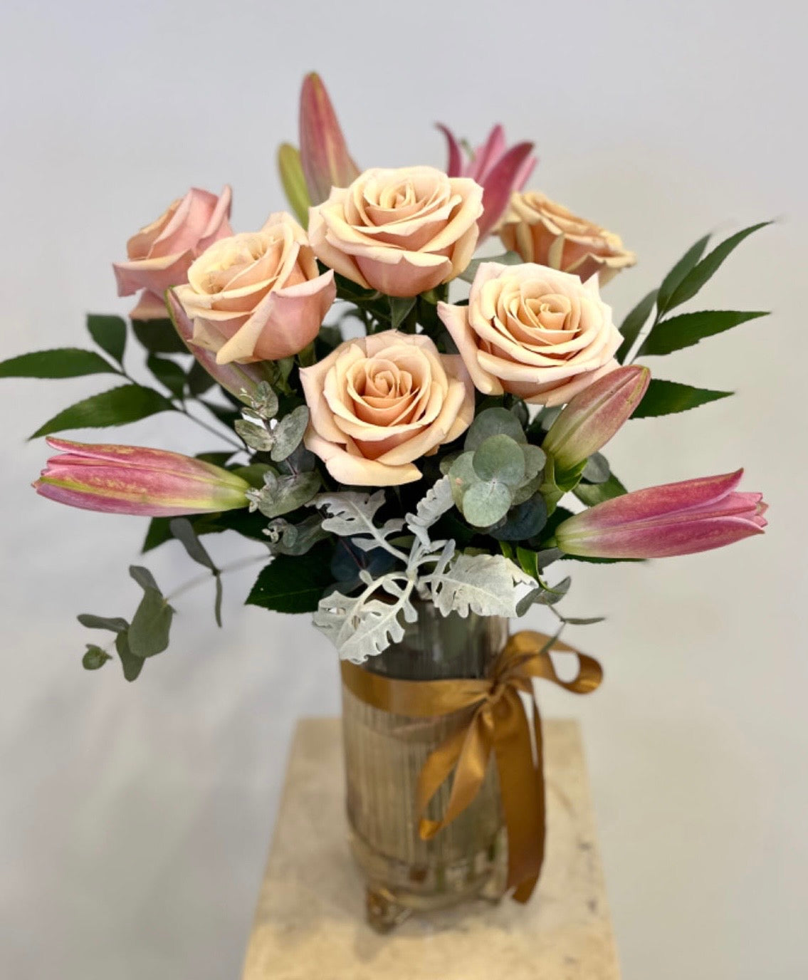 Antique pink roses and lilies in glass vase with gold ribbon, floral arrangement, gift bouquet