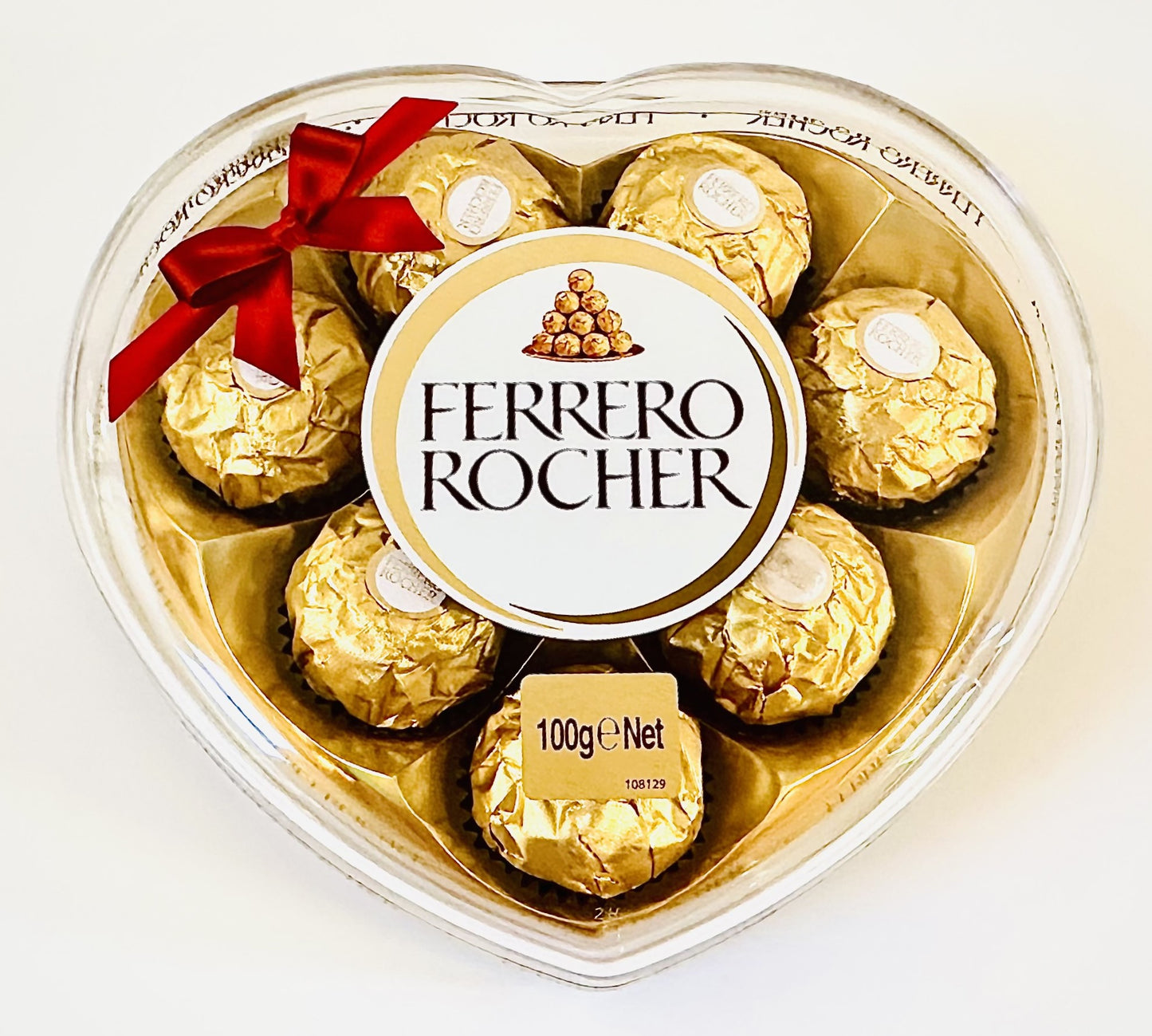 Heart-shaped Ferrero Rocher chocolate gift box with red ribbon and gold foil wrappers