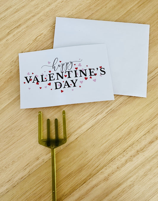 Valentine's Day greeting card with envelope and fork on wooden table, love and gift concept
