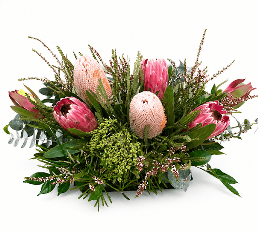 Premium Australian native table arrangement featuring pink proteas and banksias.