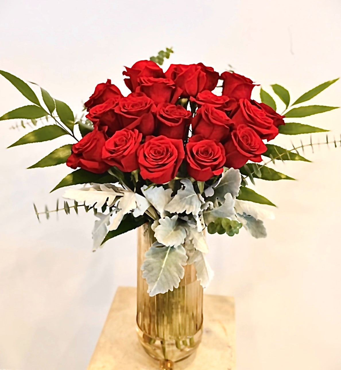 Fresh red rose bouquet with greenery in gold vase, romantic flower arrangement