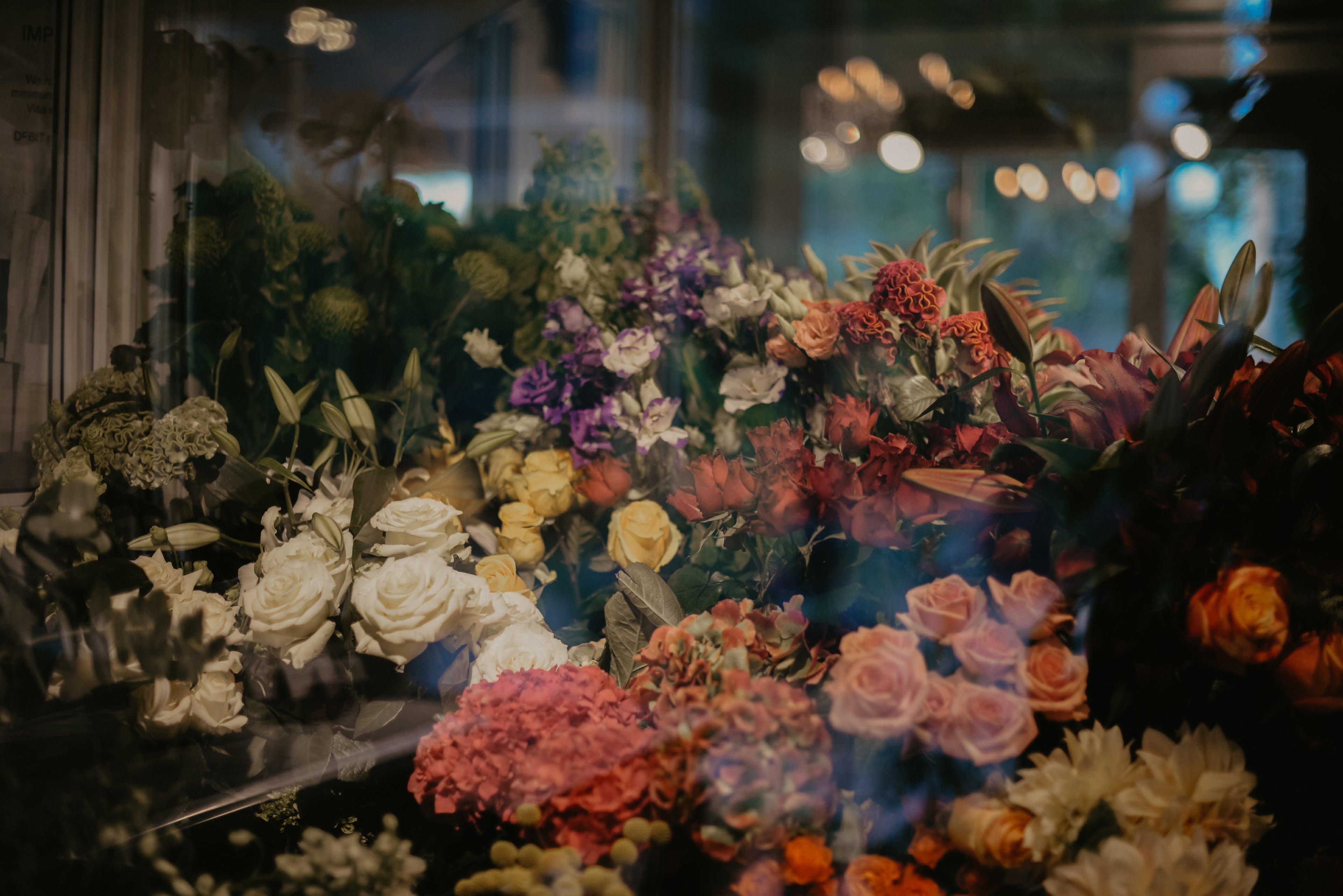 Exterior view of Spring Hill Florist store with floral displays visible through glass windows.